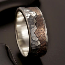 Detailed close-up of the handcrafted mountain peaks and rustic silver texture