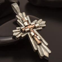 Detailed close-up of the rustic, hand-forged texture on the silver cross.