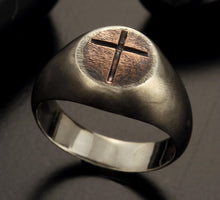 Close-up of the engraved cross symbol on the textured copper inlay.