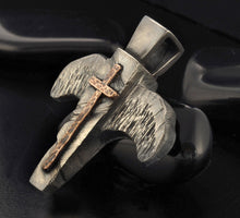 Close up of rustic hammered texture on a silver and copper mens necklace.