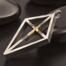 Detailed view of the architectural silver frame and delicate gold cross detail, model P-165