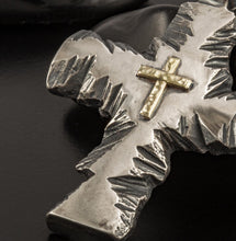 Handmade gold and silver cross necklace shown on a man's neck for size reference