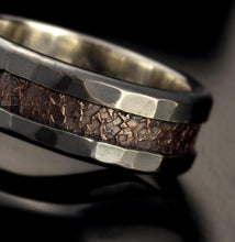 The artisan 1411 ring inside a luxury black jewelry box with a branded cloth