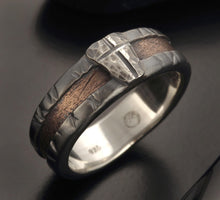 Detailed view of the hand-forged rugged texture on the copper and silver wedding band
