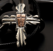 Close-up of the rustic copper shield version, showing the warm contrast against the polished sterling silver frame