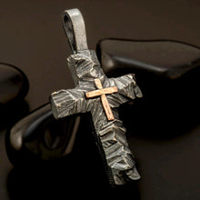 Detailed organic texture of oxidized silver and copper cross, handmade artisan spiritual necklace.