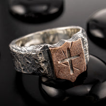 Front view of RS-1424 mens signet ring, featuring a rustic sterling silver band with a raw copper shield and an engraved cross.