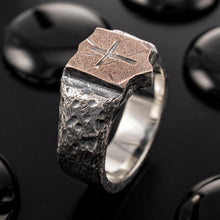Extreme close-up of the engraved cross on the copper surface, highlighting the artisan craftsmanship and oxidized silver details.