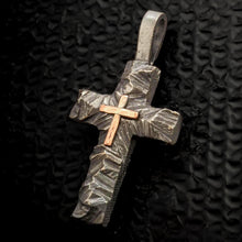 Large mixed metal cross pendant for men, showing the contrast between copper and silver on hand