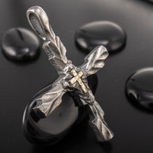 Side view of the P-178 cross pendant, showing the thick sterling silver construction and the deep, organic hammered texture on the edges.