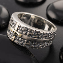 Close-up of the smooth, polished inside of the men's wedding band, showing the contrast with the textured exterior.